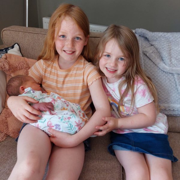 Maisie and Gracie delighted with their new sister Darcie.