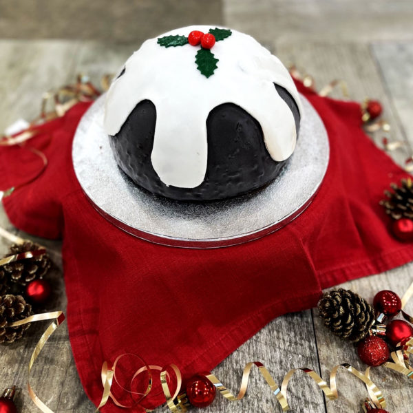 Christmas Pudding ice cream cake is filled with Christmas Pudding ice cream with a sweet, dried fruit and candied peel sauce, coated in a chocolate sauce and decorated with white fondant icing.